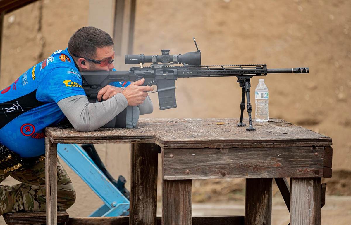 3 gun competition shooter with long range rifle
